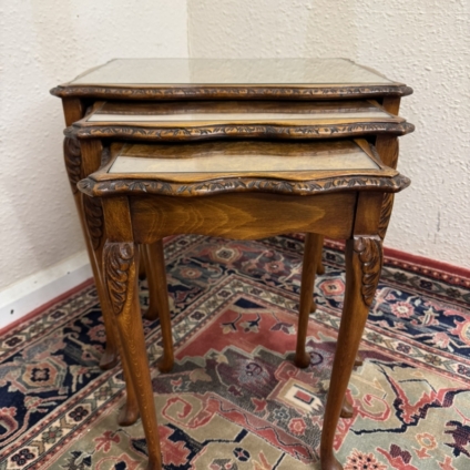 OUTSTANDING QUALITY CARVED WALNUT NEST OF THREE GLASS TOPPED TABLES CIRCA 1950